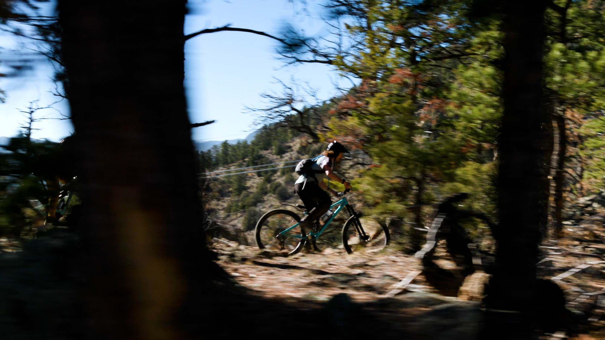 mountain biker riding through forest trail captured for outdoor brand campaign video production