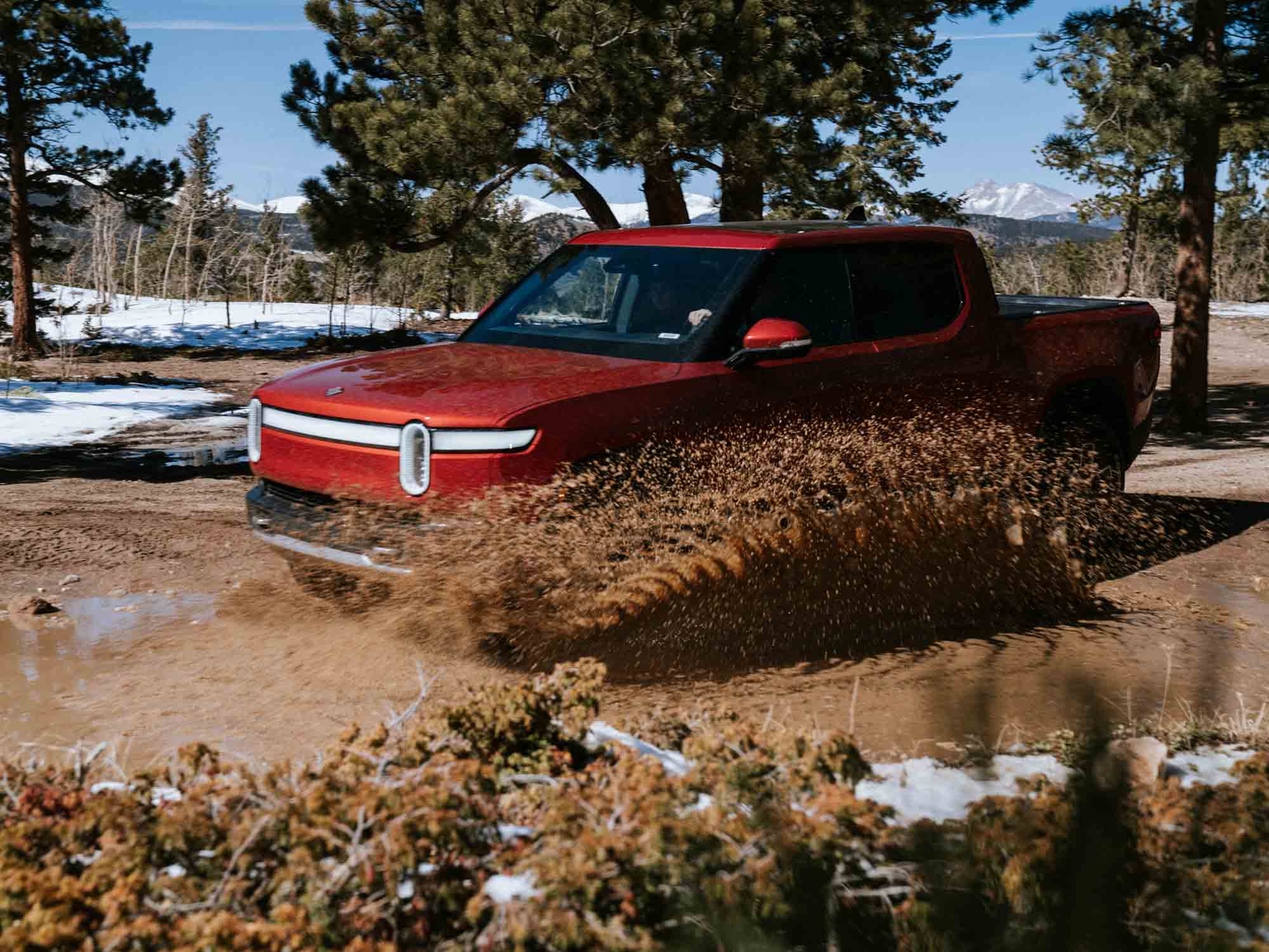 electric truck driving through mud off road filmed for automotive commercial video production